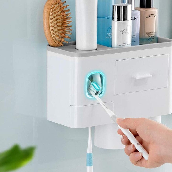 Model using toothpaste dispenser with toothbrush