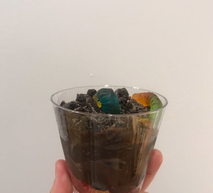 Cup of chocolate pudding, Oreos, and gummy worms