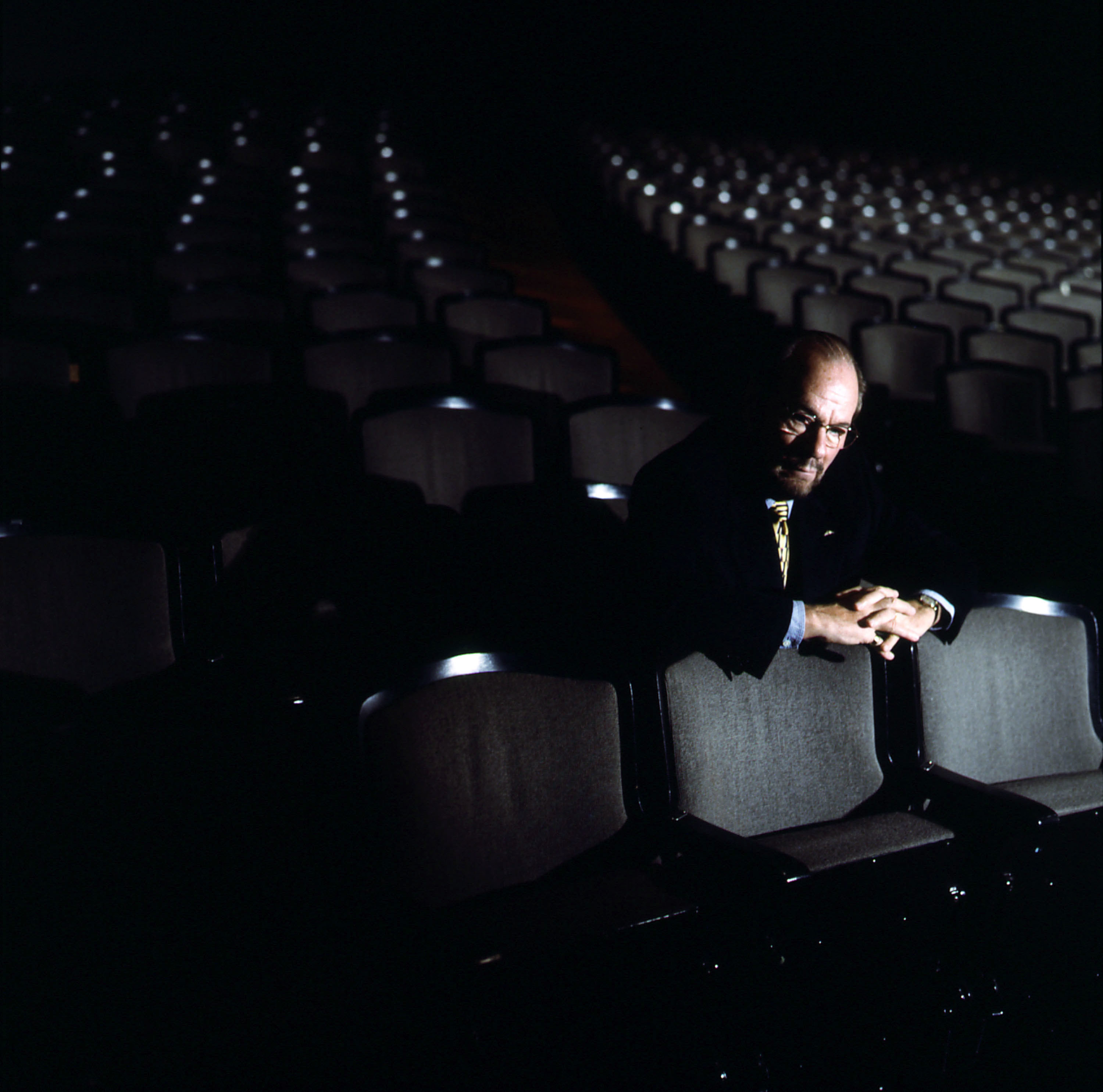 Lipton alone among many empty seats in a theater