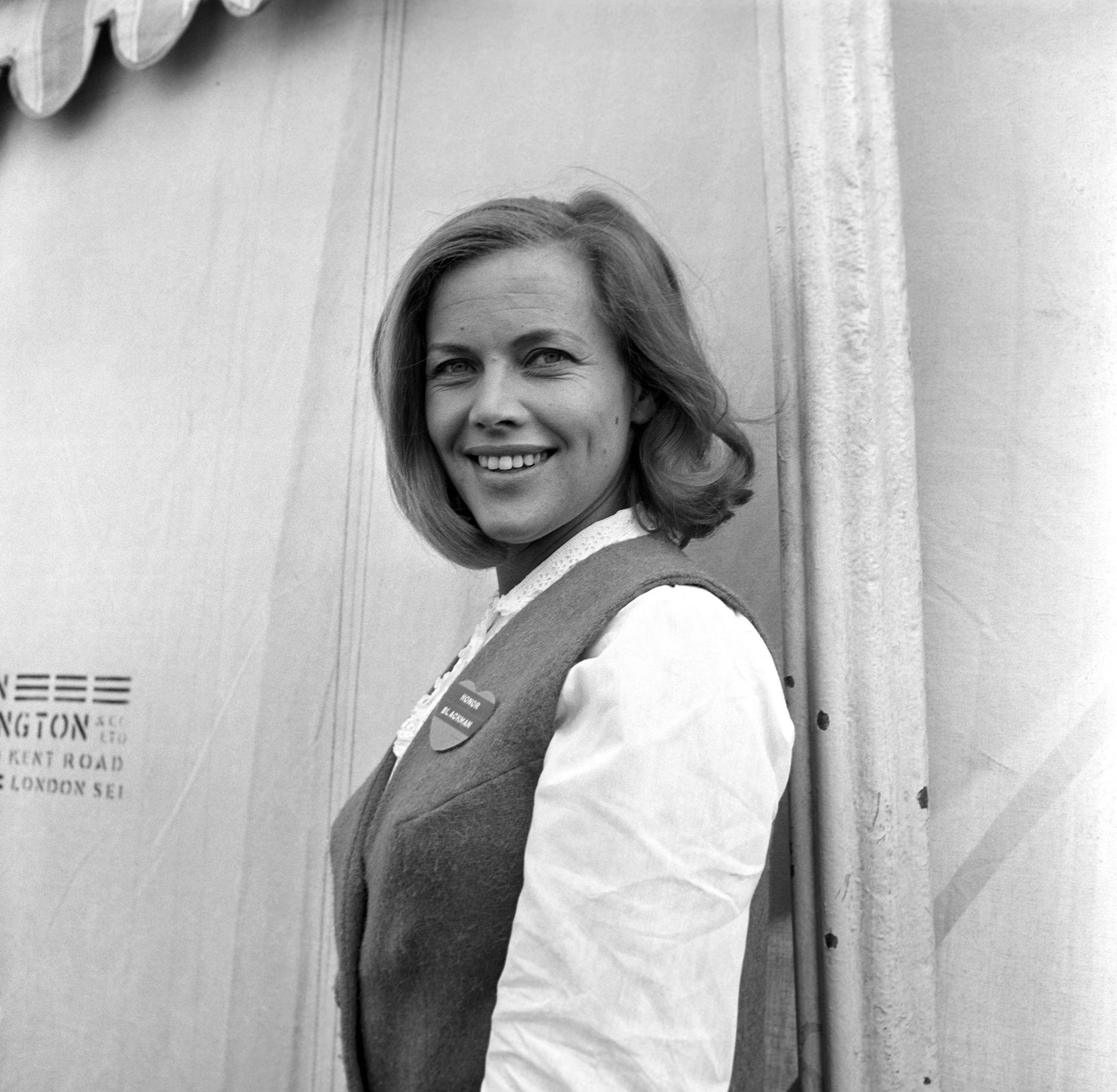 Honor Blackman in a vest on a movie set