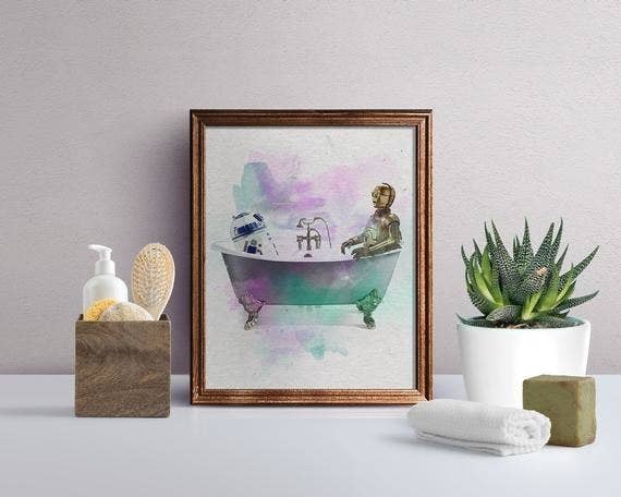 Star Wars-inspired art print of R2-D2 and C-3PO in a colorful bathtub on top of bathroom vanity