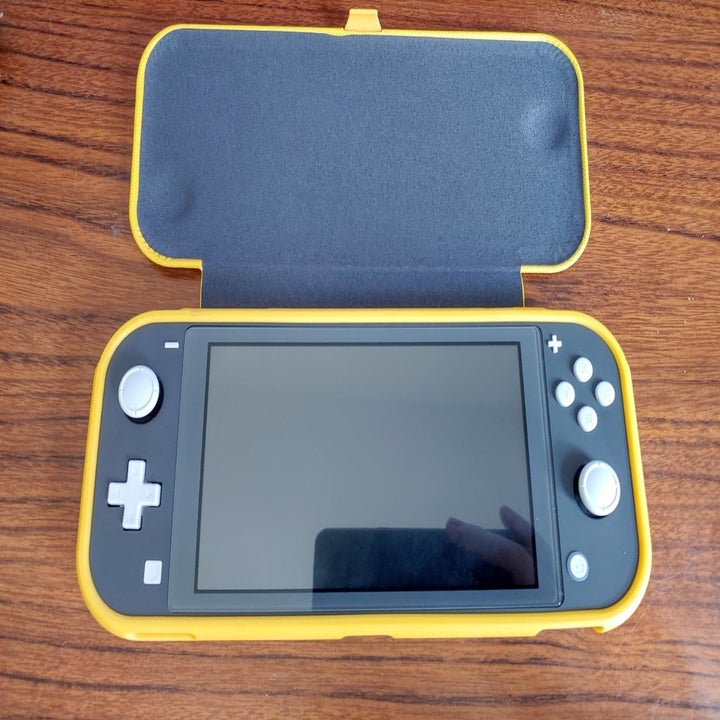 Yellow flip-cover case on Nintendo Switch Lite in opened position
