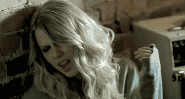 a gif of taylor swift singing in the &quot;white horse&quot; music video