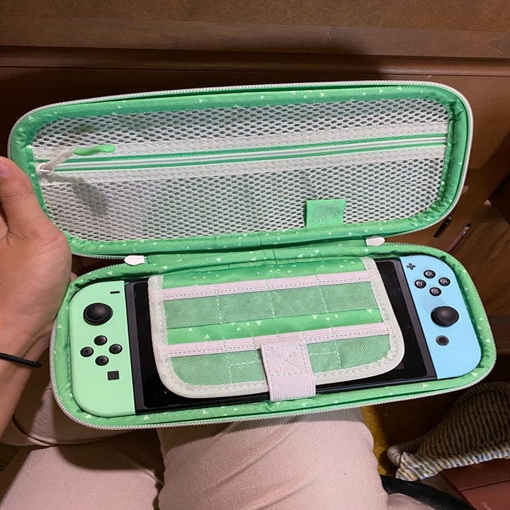 Amazon reviewer holding opened Animal Crossing-themed Nintendo Switch case