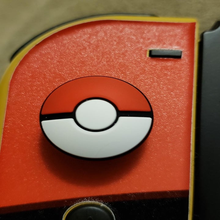 Amazon reviewer photo of joy-con with Pokéball-themed joystick grip