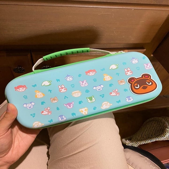 Amazon reviewer holding Animal Crossing-themed Nintendo Switch case