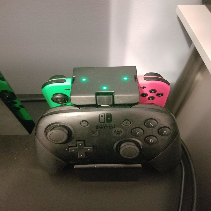 Reviewer photo showing charging lights on top of charging dock
