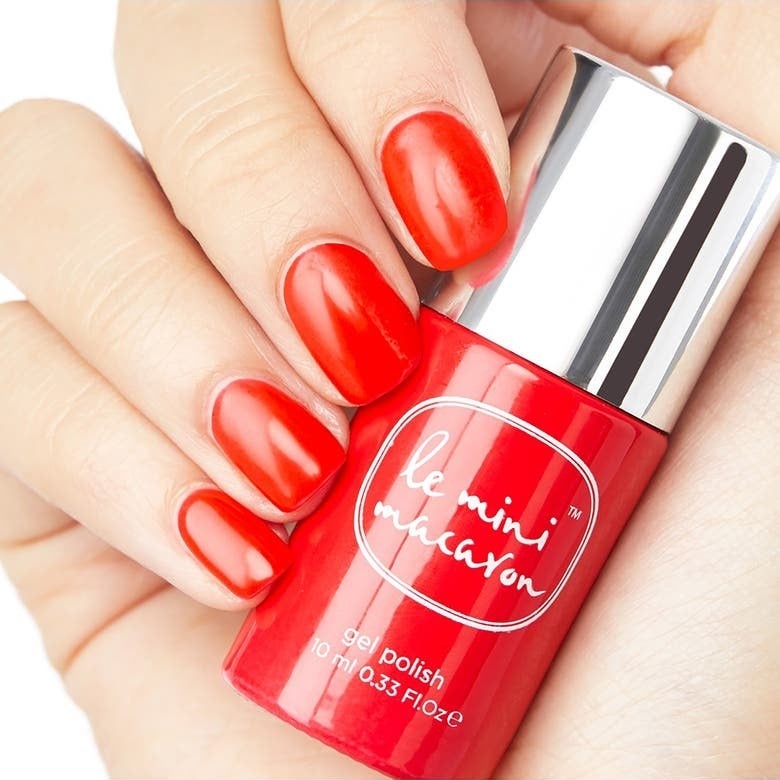 Model wearing bright red polish