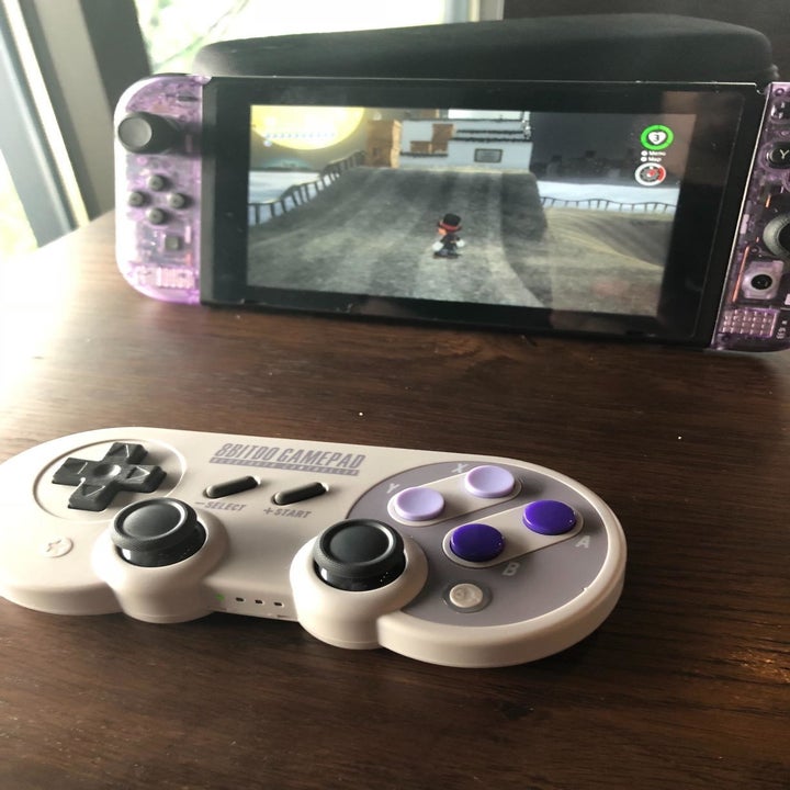 Reviewer photo of Super Nintendo-style controller in front of Nintendo Switch