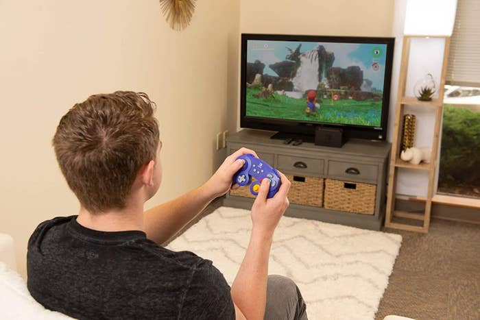 Model using the controller to play Mario
