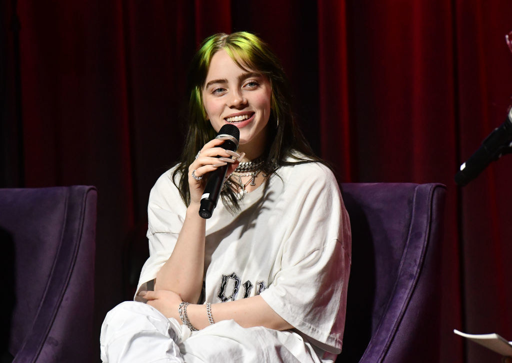 Billie speaking at an event and smiling