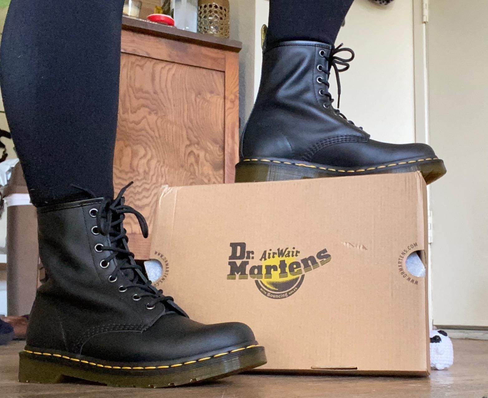 a reviewer wearing the black combat boots