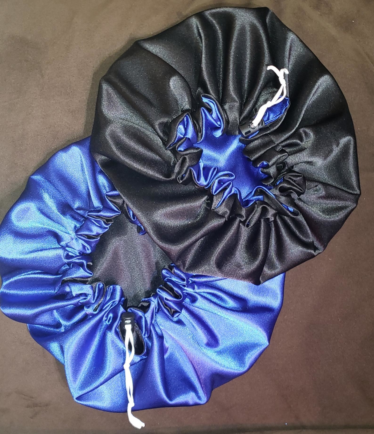 Two reversible satin bonnets in black and blue 