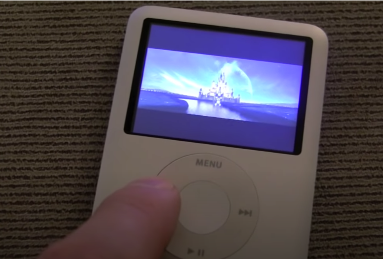 A finger pushing the button on an iPod Nano playing a Disney movie.