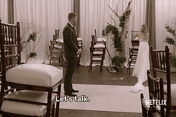 One of the brides putting down a chair and saying, &quot;Let&#x27;s talk&quot;