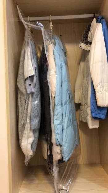 Reviewer clothes inside the bags hanging in a closet