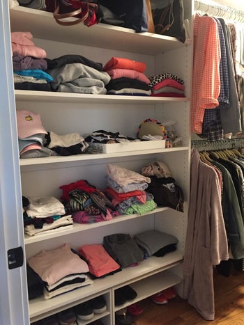 A closet of clothes that are neatly organized but kinda smushed together