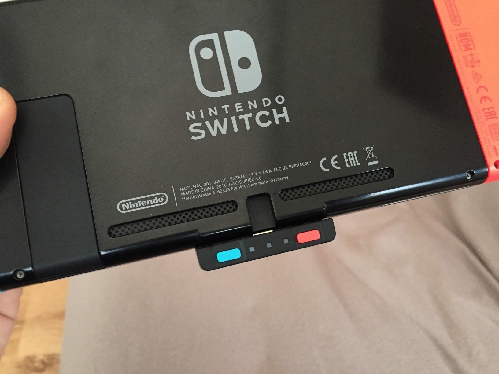 Bluetooth audio transmitter connected to bottom of Nintendo Switch