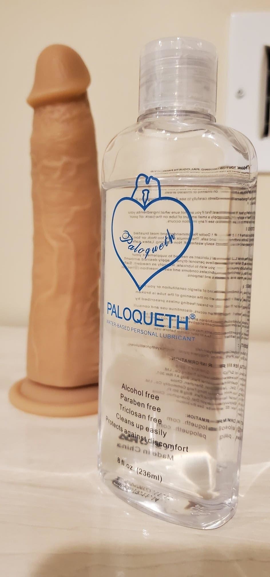 reviewer image of a bottle of paloqueth water-based lubricant next to a silicone dildo