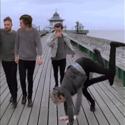 One Direction walking with Niall doing a cartwheel
