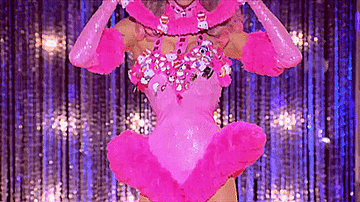 Drag queen Violet Chachki wearing a pink Hello Kitty themed, 60&#x27;s style leotard with matching headpiece and gloves, and exaggerated hips