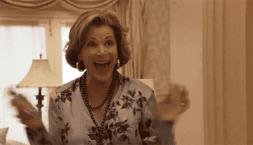 Lucille Bluth looking excited and waving her hands