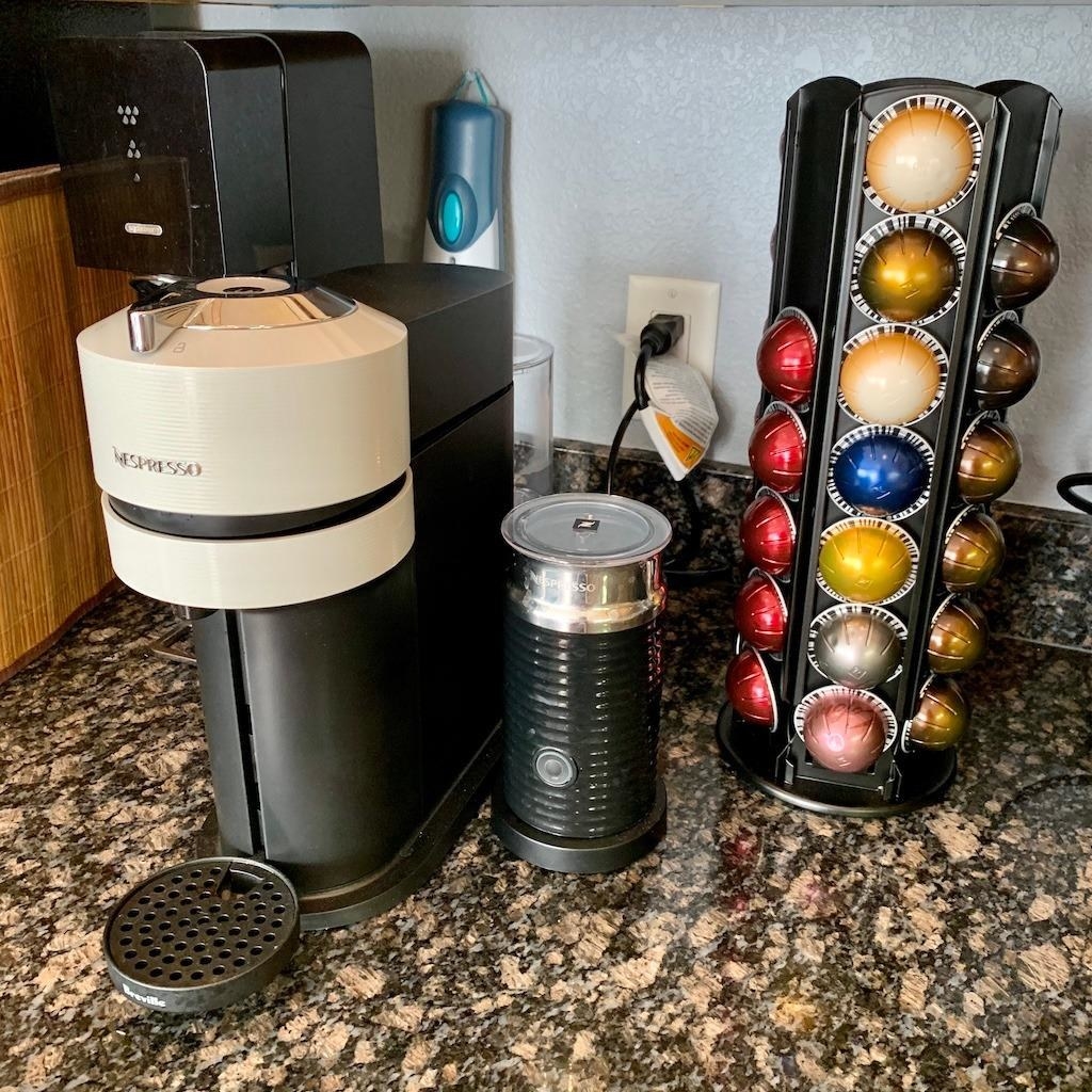 The Nespresso machine, Aeroccino milk frother, and Nespresso pods