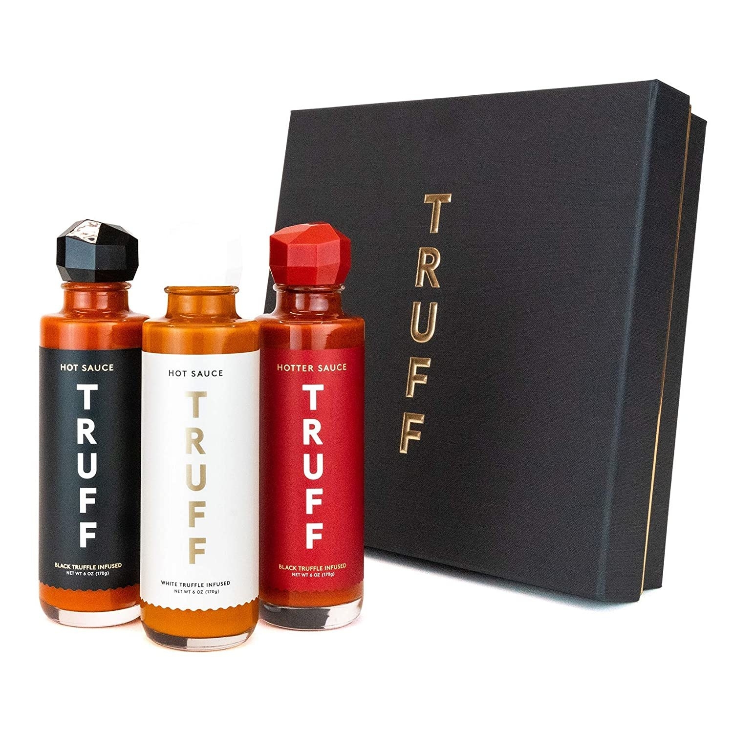 Three bottles of Truff hot sauce next to gift box