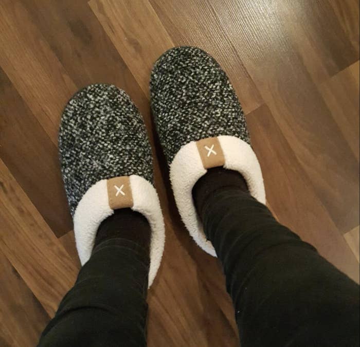 Reviewer in slip on white and black marled slippers with fleece-y lining 