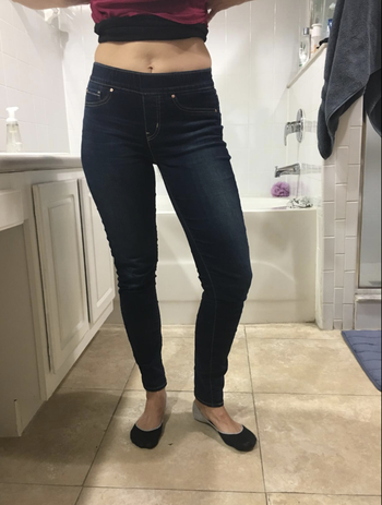 A customer review photo of them in the medium wash denim skinny jeans 