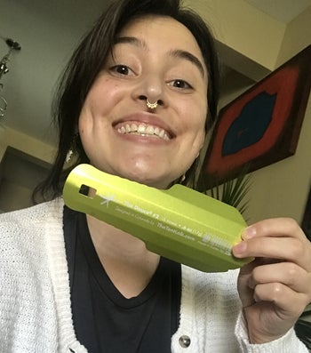 the writer smiling holing a green deuce trowel