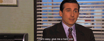 a man in a suit and tie at his desk says &quot;give me a hard one&quot;
