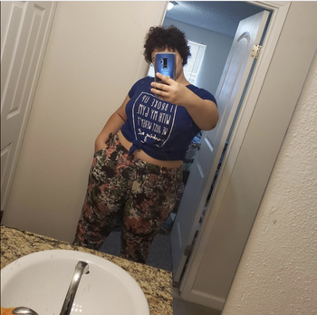 Reviewer in black and pink and white floral joggers 