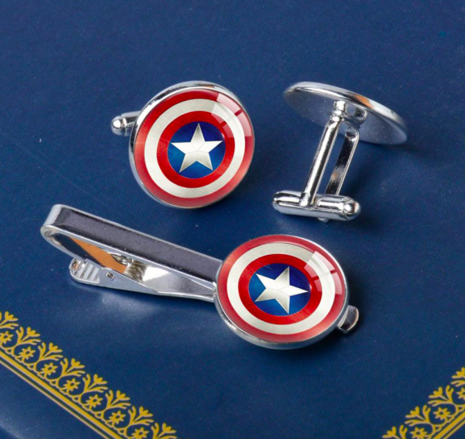 A set of cuff links and a tie clip emblazoned with captain america&#x27;s iconic shield design