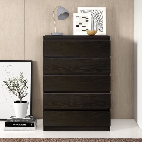 The dresser, which has drawers with smooth, handle-less front panels