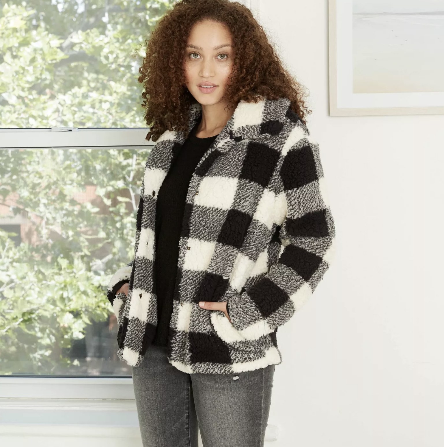 Model is wearing a black and white checkered jacket