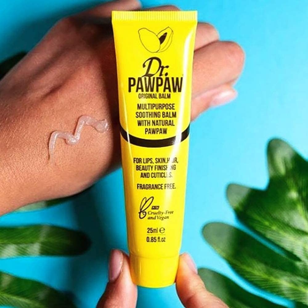 The yellow tube of original Dr. PAWPAW and a model showing the vaseline-like consistency of the product