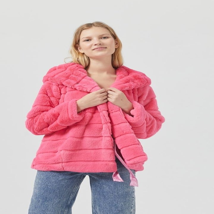 a model in a pink faux fur coat