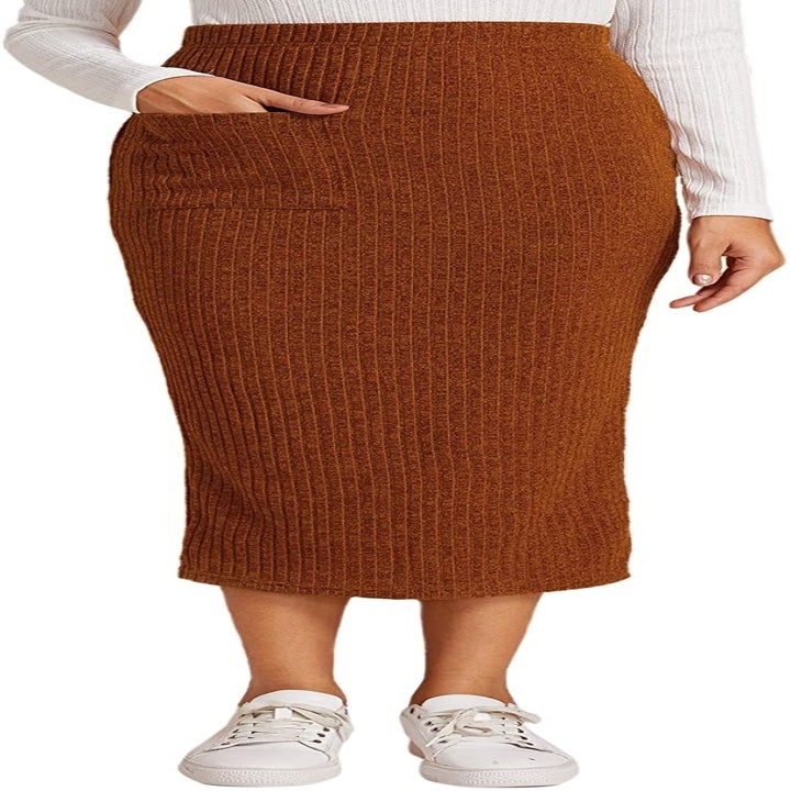The brown skirt with a hand in the pocket on one side