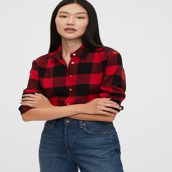a model in a red and black flannel shirt