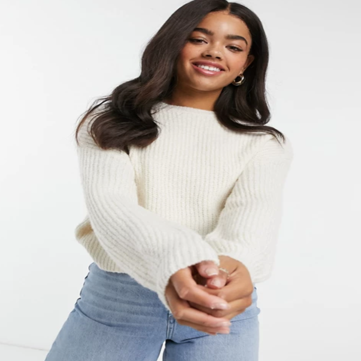 a model in a white sweater