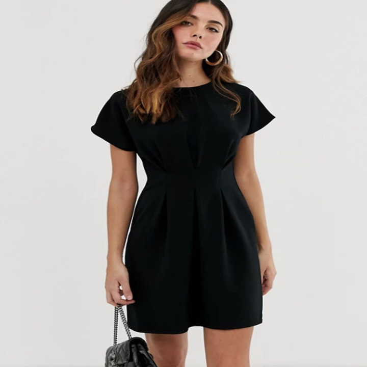 a model in a black t-shirt dress