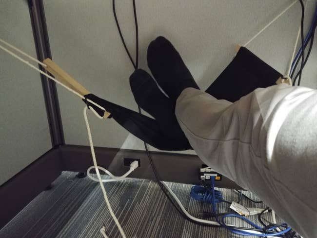 reviewer image of their feet resting in the same foot hammock