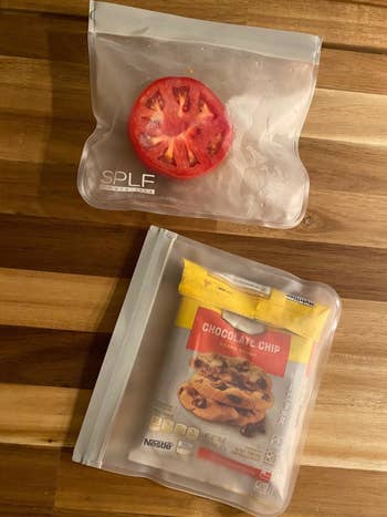 A reviewer's photo of two bags holding half a tomato and a bag of open cookie dough