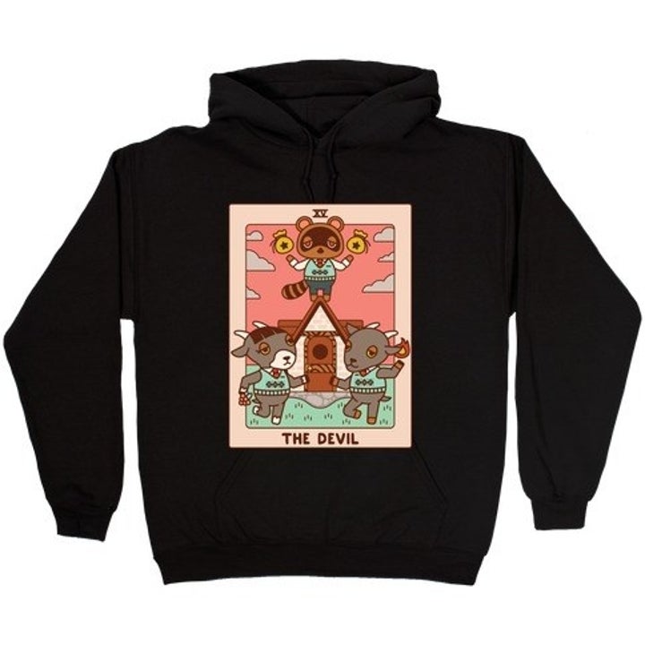 a black sweatshirt with a devil tarot card on it featuring animal crossing's tom nook