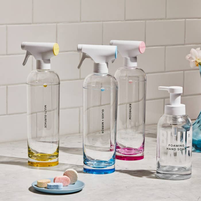 The Clean Essentials kit&#x27;s cute spray bottles, tablets, and hand soap pump