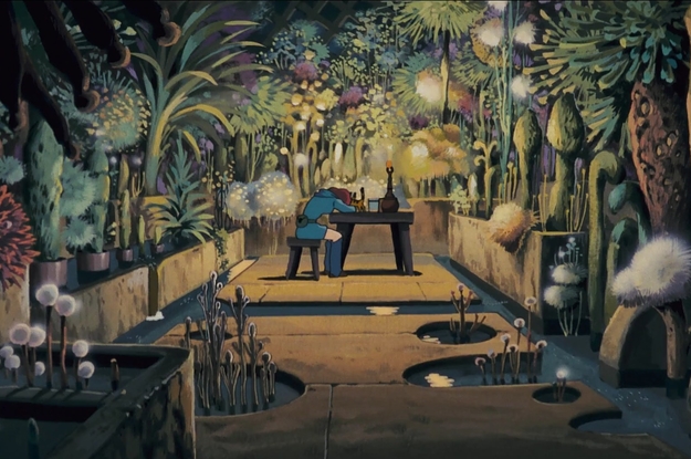 A girl at a desk in the middle of a room with an abundance of unusual plants