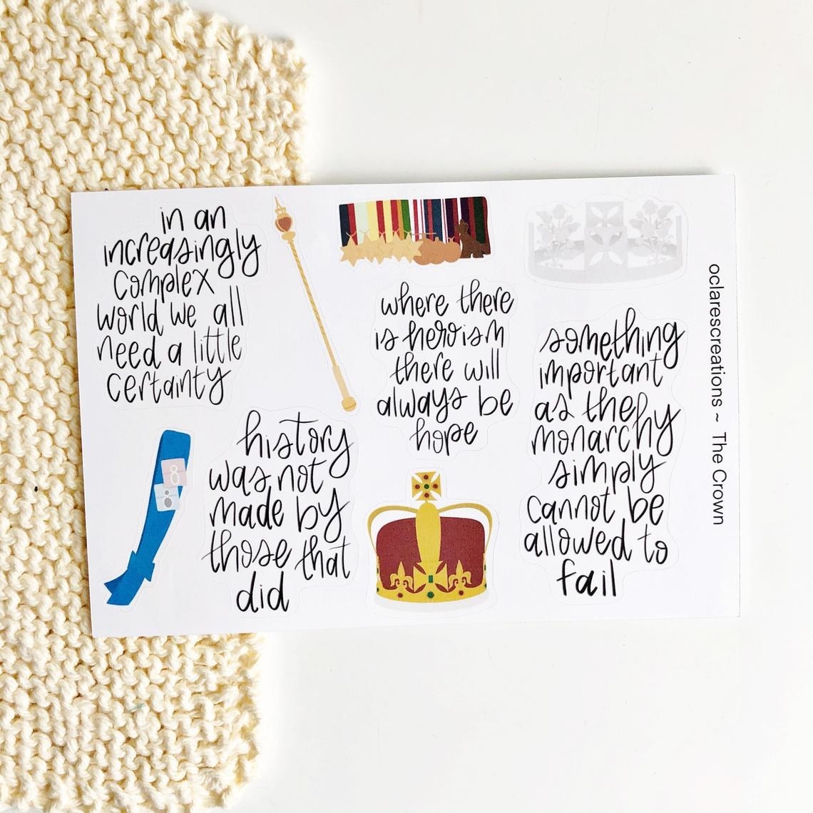 A sheet of stickers that have quotes from The Crown like &quot;history was not made by those that did&quot; and &quot;in an increasingly complex would we all need a little certainty,&quot; as well as drawings of royal garb like a crown, a sash, and a scepter