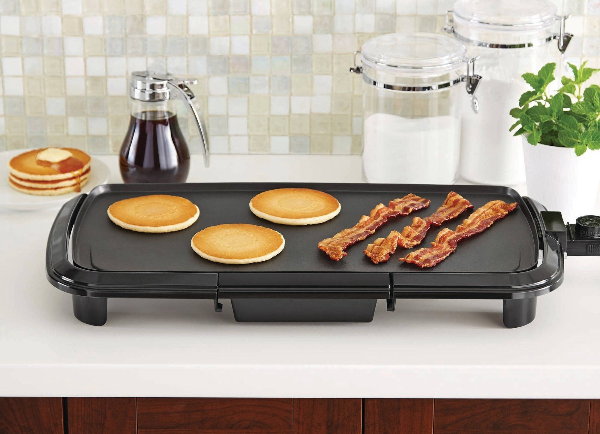 The black griddle with pancakes and bacon
