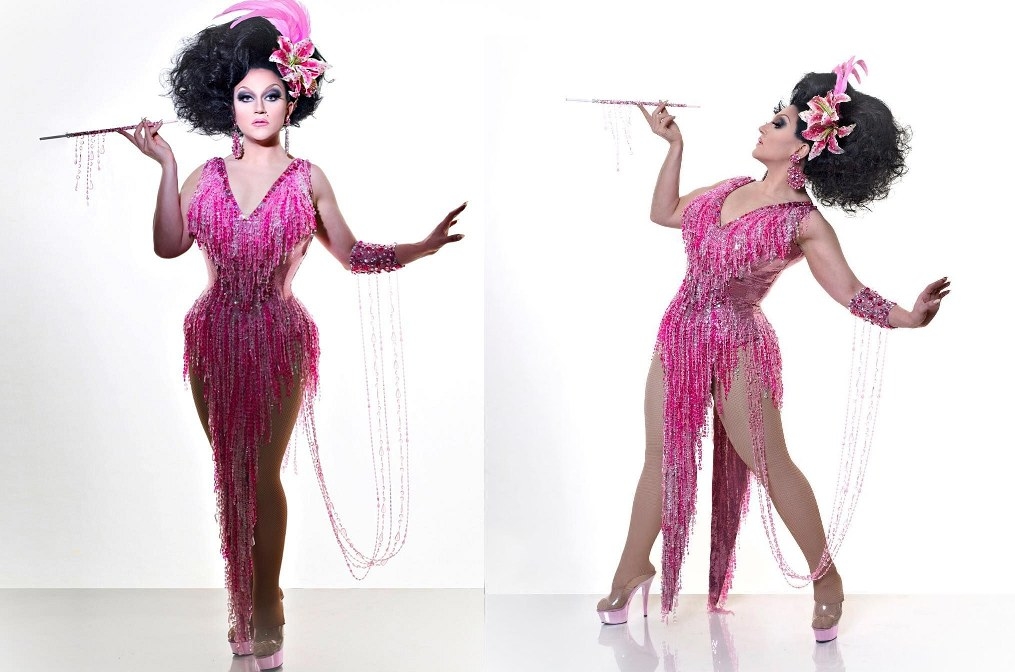 Drag queen BenDeLaCreme wearing a heavily beaded pink flapper-style outfit with draping jewels and a flower fascinator
